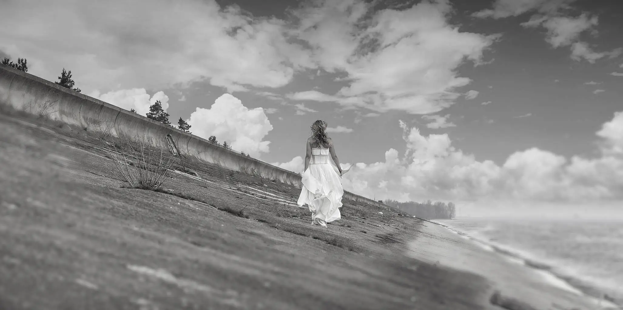 Black and white photo of a woman walking along a hillside path, from Alex Makarov's photography portfolio